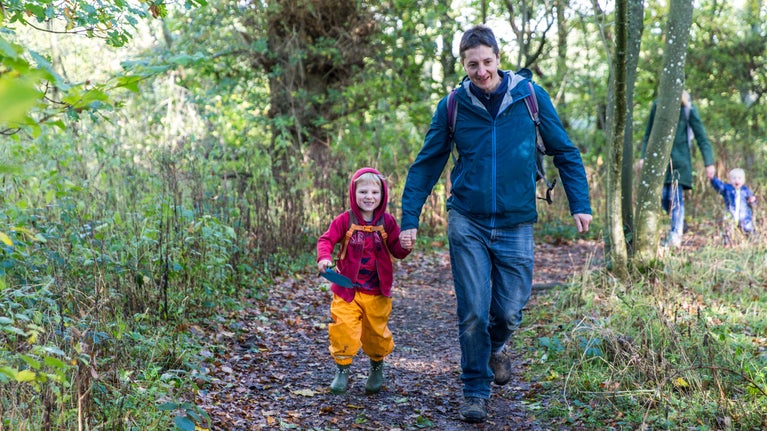 Visitors following the woodland walk to the watermill at Acorn Bank, Cumbria